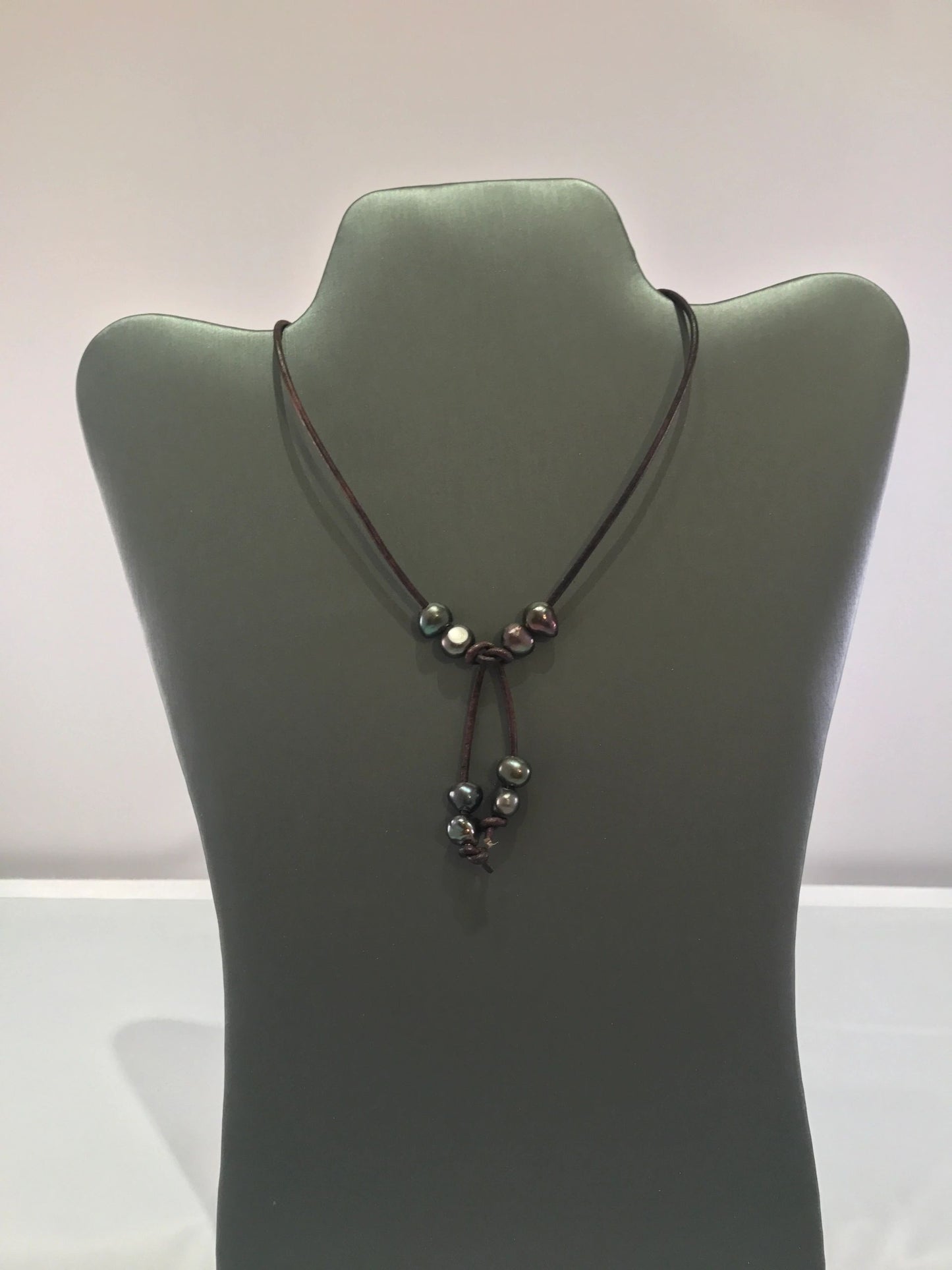 White or dark freshwater pearl lariat necklace on leather cord