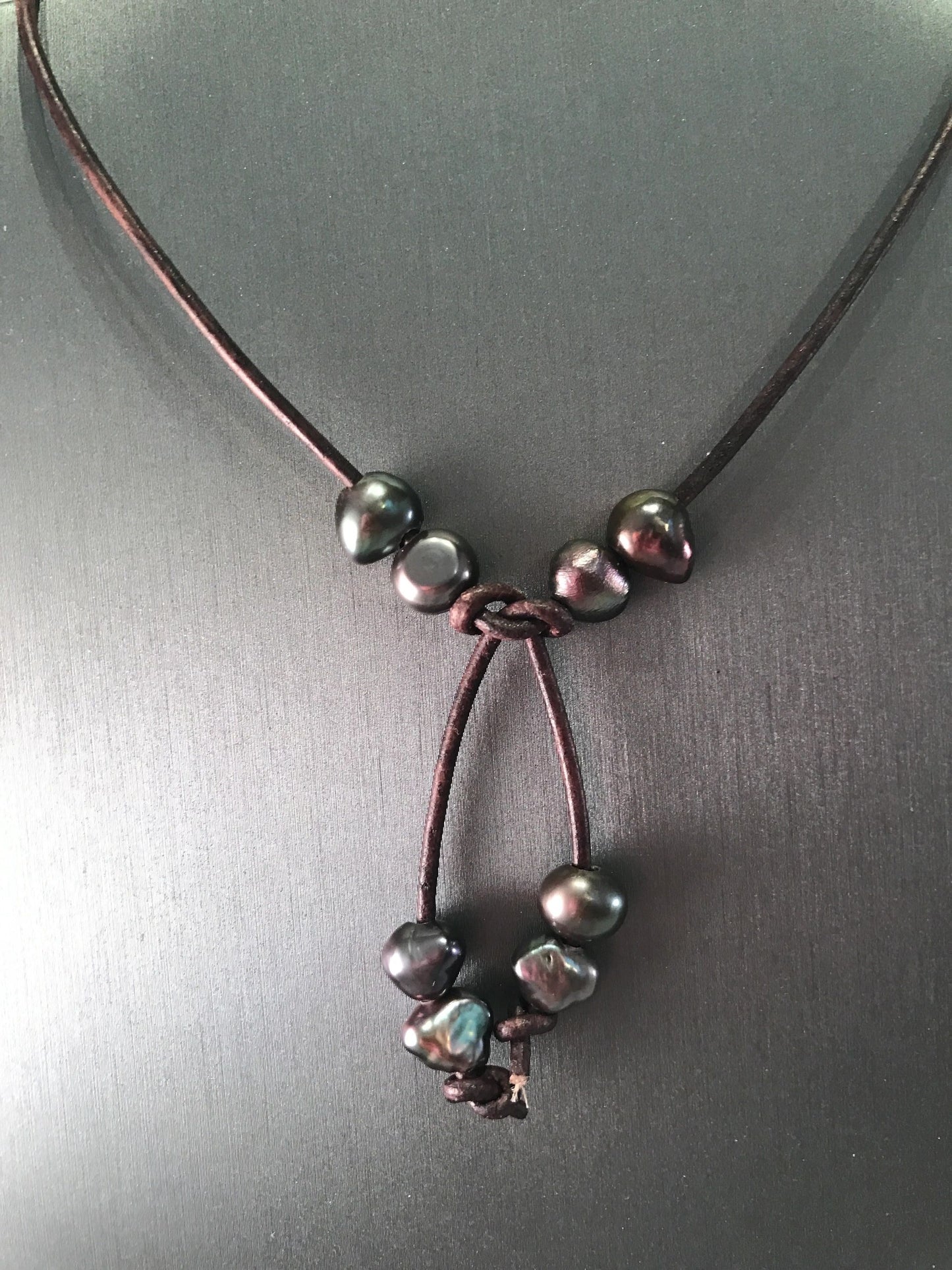 White or dark freshwater pearl lariat necklace on leather cord