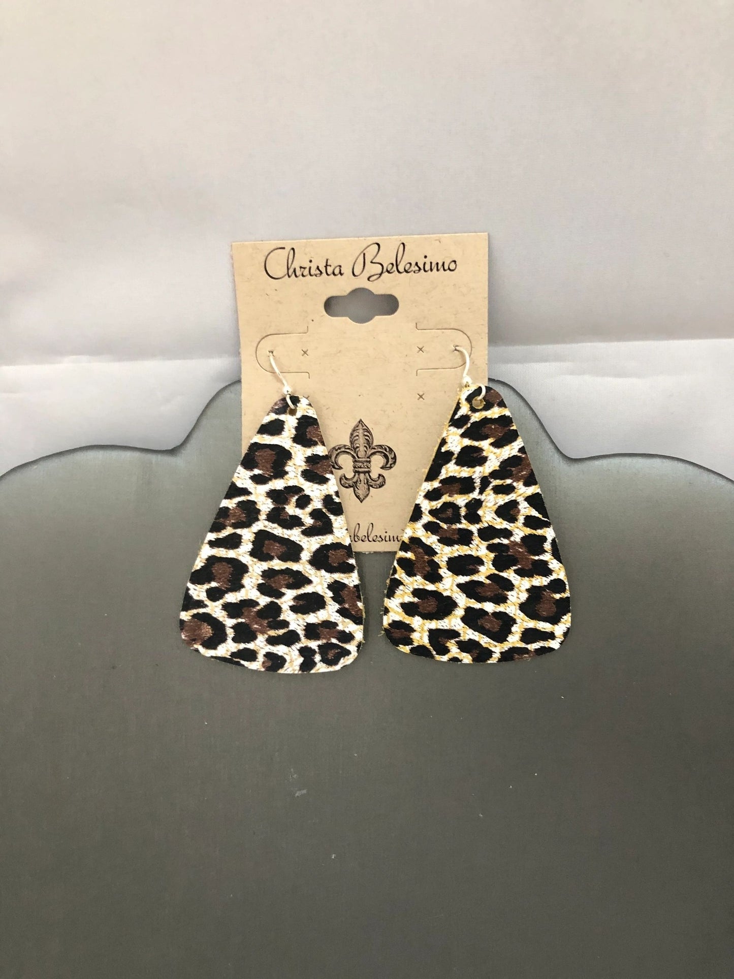 Vegan leather earrings with leopard and cheetah print design, displayed on a card with the brand name 'Christina Salerno'.