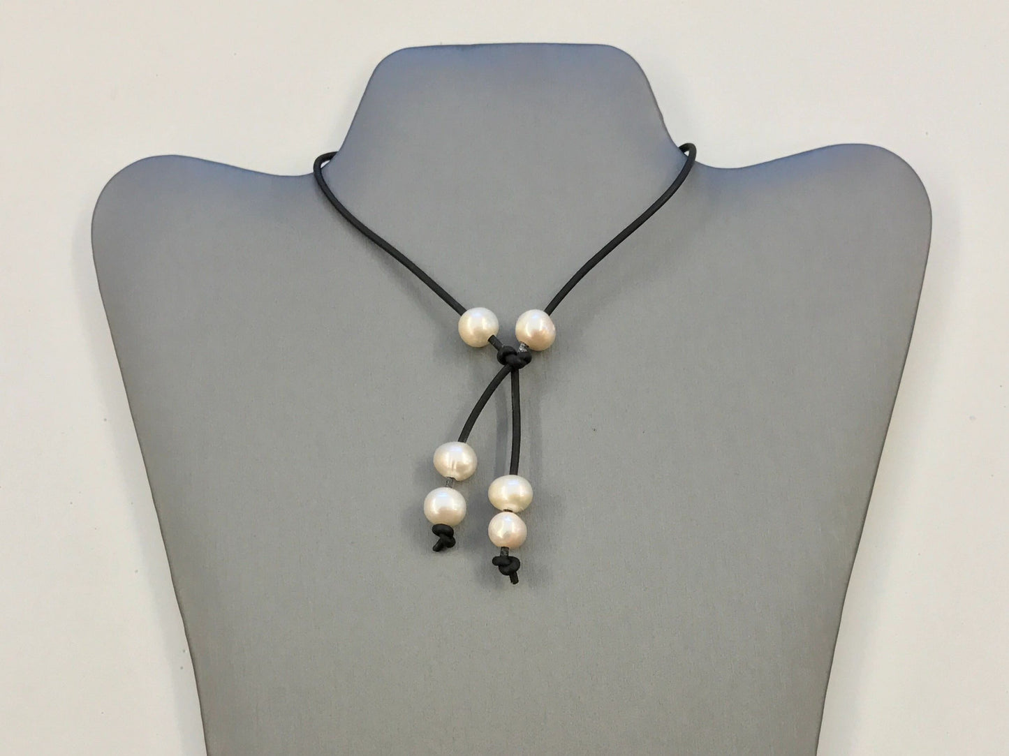 White or dark freshwater pearl lariat necklace on leather cord