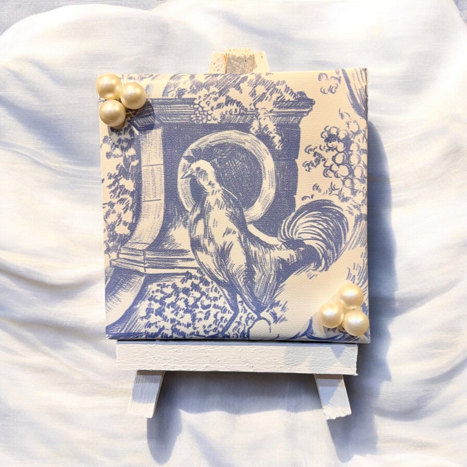 	Blue chinoiserie mini art print with pearl accents on easel