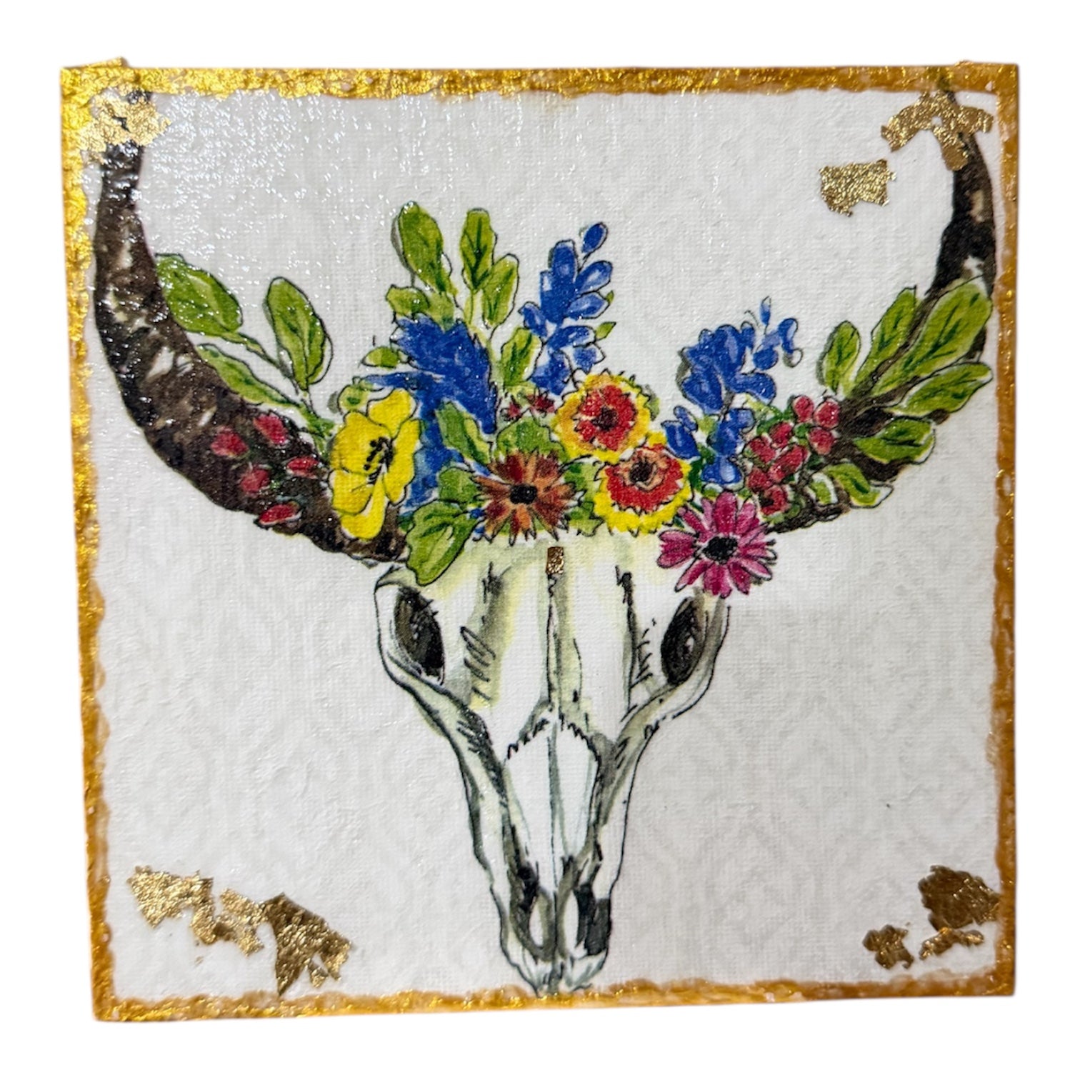Decorative piece with a deer skull and colorful flowers on a white background with gold accents.