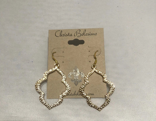 Gold tone quatrefoil earrings displayed on a card with the brand name 'Christina Balzini'.