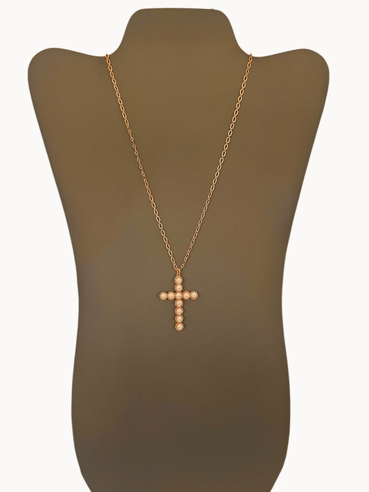 A Gold Pearl Cross Necklace displayed on a mannequin bust. The necklace features a gold-filled chain with a gold cross adorned with pearls.