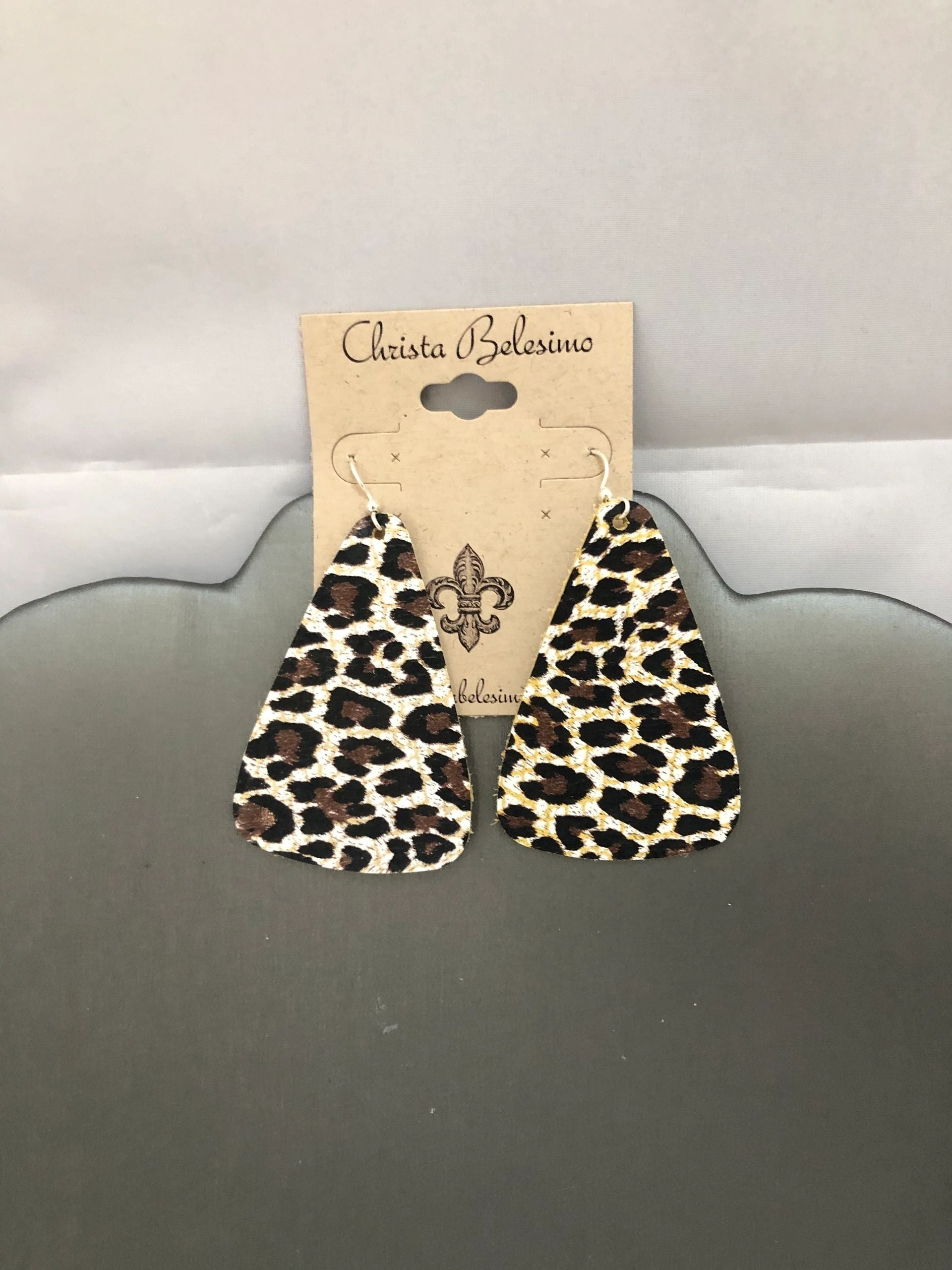 Vegan leather earrings with leopard and cheetah print design, displayed on a card with the brand name 'Christina Salerno'.