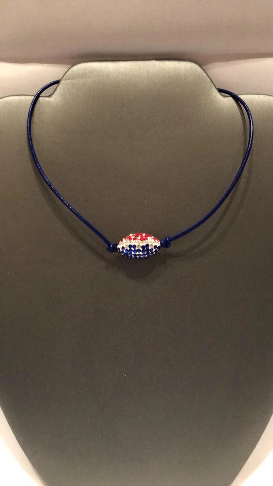 A blue leather cord necklace with a silver lobster clasp featuring a pave' football pendant with Patriot's or Houston Texan colors.