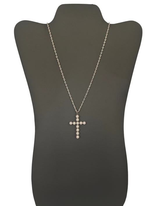 A silver pearl cross necklace displayed on a mannequin bust.