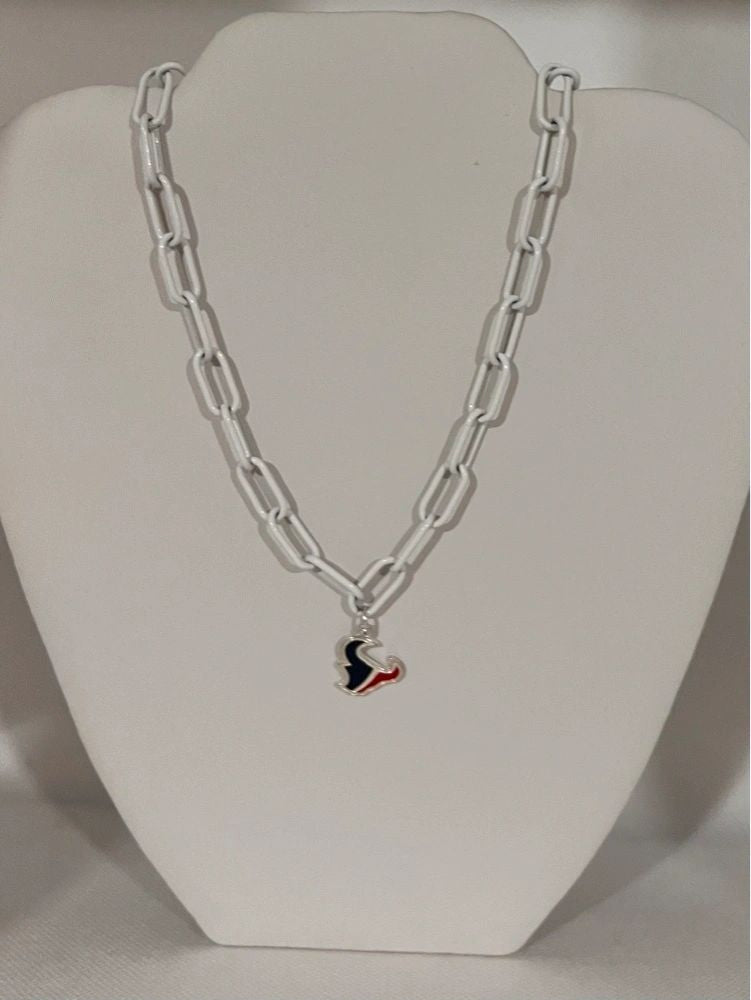 A white enamel necklace with a large paper clip style pendant featuring the Houston Texans logo.