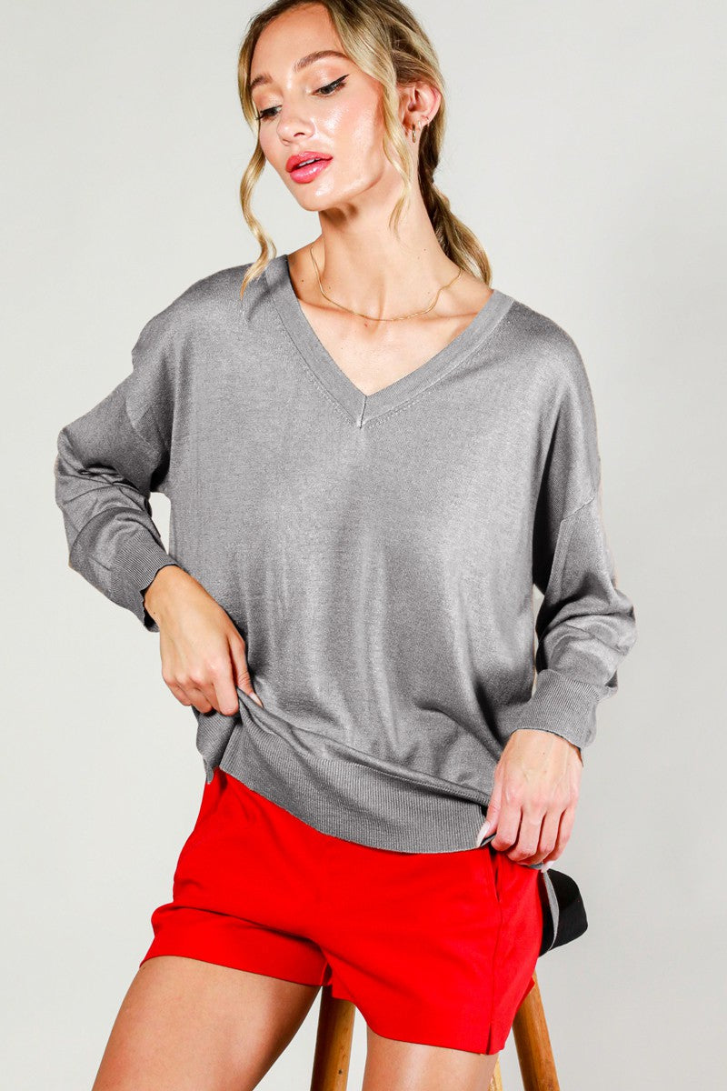 Woman wearing lightweight gray sweater 